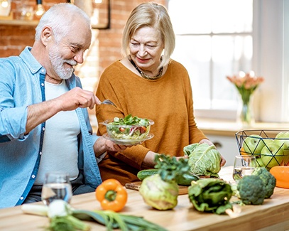 Senior man and woman looking at a salad