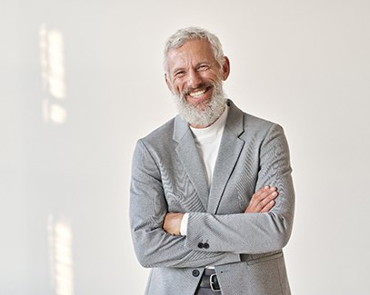 Senior man in a grey suit smiling