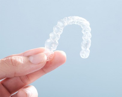 Patient holding clear aligner