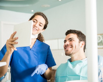 Dentist showing patient image on tablet