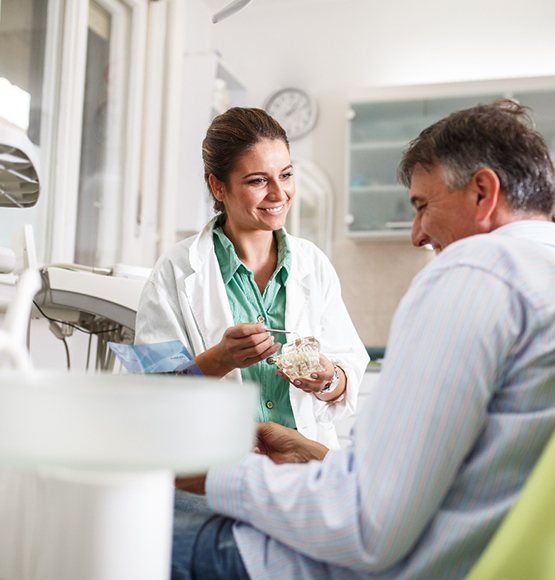 A dentist chatting with her patient before a dental checkup