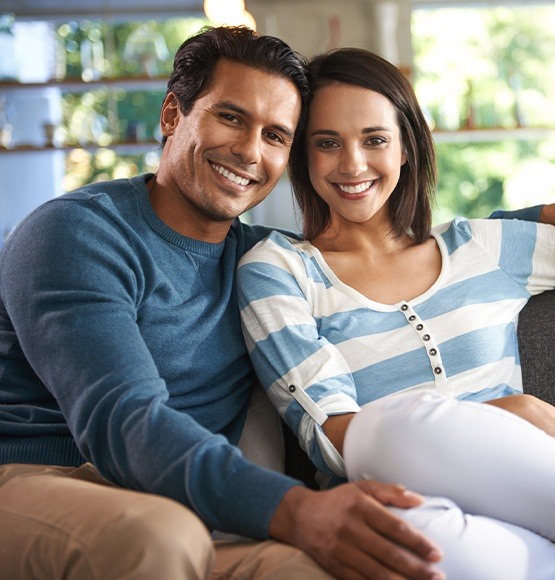 Man and woman with healthy smiles after metal free dental crowns