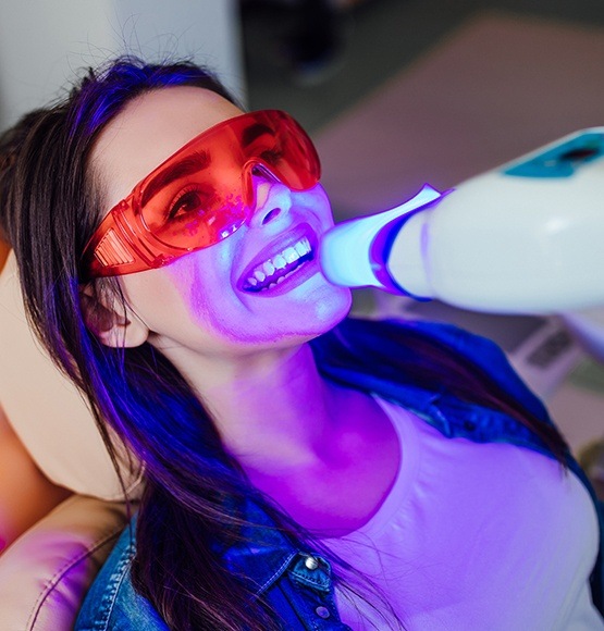 Woman receiving in office teeth whitening