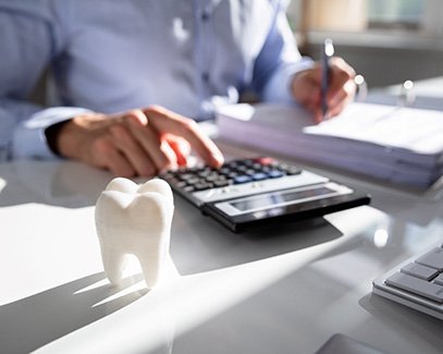 dentist calculating the cost of cosmetic dentistry in Tucson 