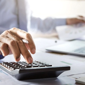 a person calculating whether they can afford dentures