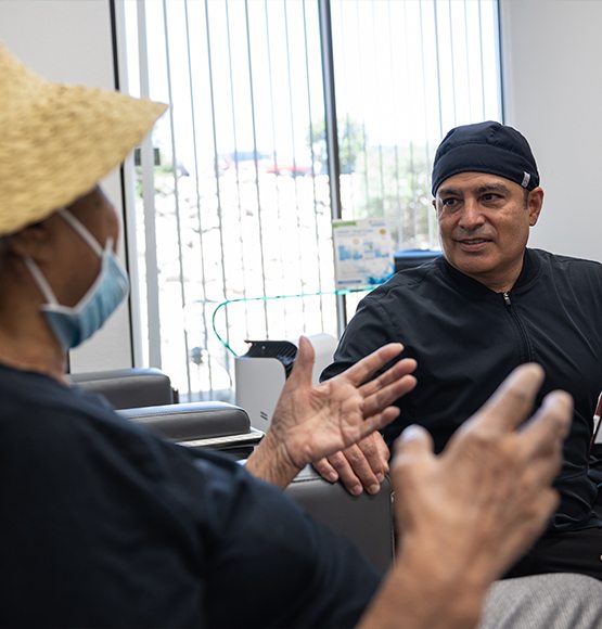 Doctor Lopez and dental patient reviewing treatment plan