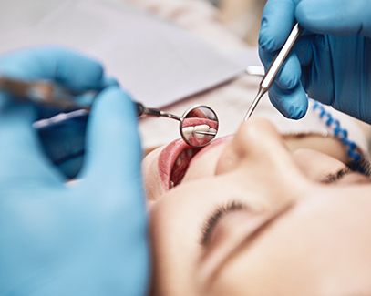 Female patient having a dental checkup performed