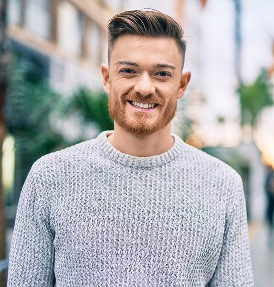 smiling person standing on the street