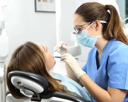 dental hygienist cleaning a patient’s teeth