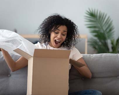 girl excitedly opening a package