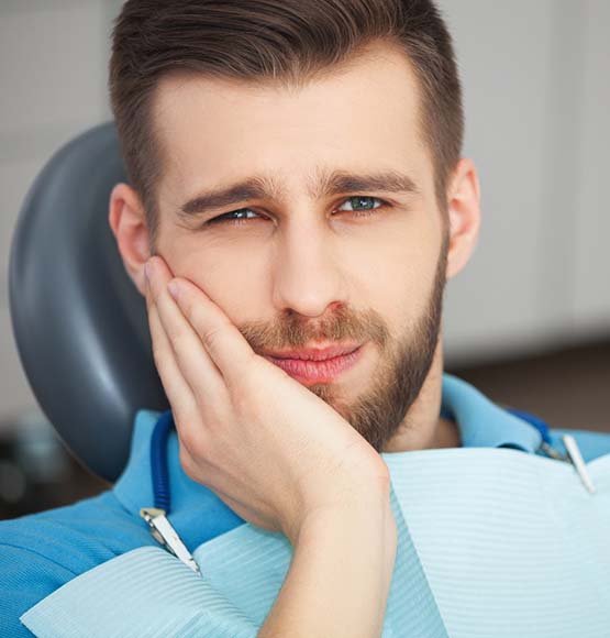 Man with toothache visiting his Tucson emergency dentist 