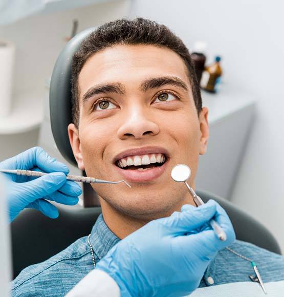 Man smiles after getting toothache treatment in Tucson