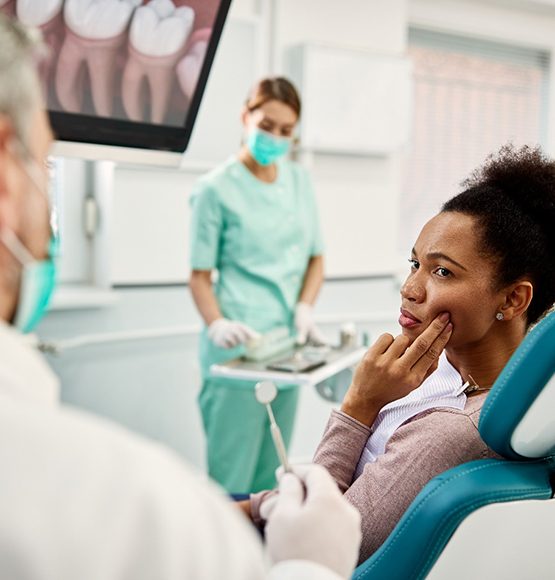 Woman in dental chair with a toothache