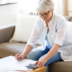 Patient looking at dental insurance paperwork for the cost of dental implants in Tucson