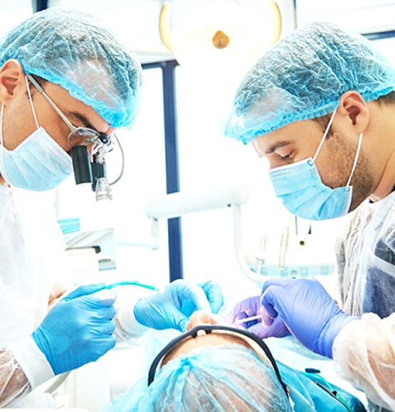 Dentists placing a dental implant in Tucson