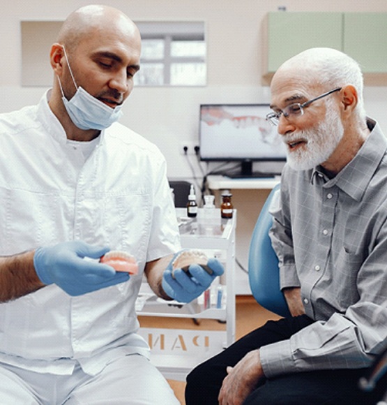 Dentist discussing eligibility for man in Tucson