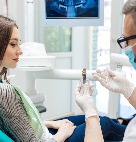 dentist explaining dental implants in Tucson