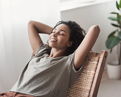 woman resting per dental implant post-op instructions in Tucson