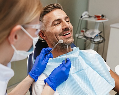 man visiting dentist for dental implant post-op instructions in Tucson