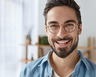 Smiling young man with dental implants in Tucson 