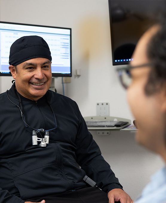 Dentist in Tucson talking to patient in dental chair