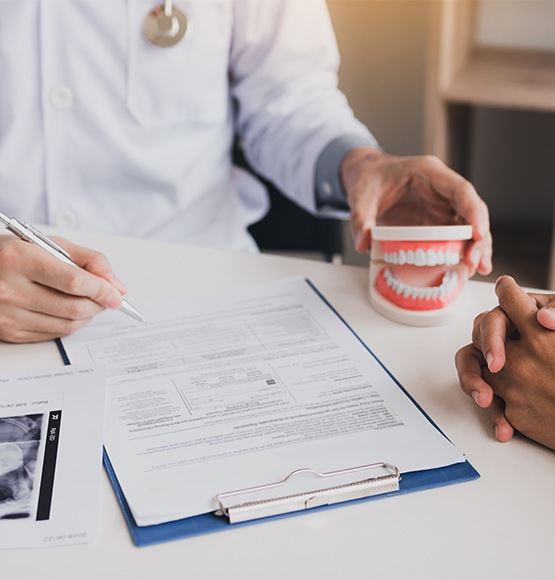 Dentist reviewing dental insurance coverage for treatment plan