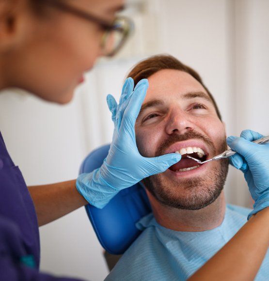 Dentist examining patient's smile