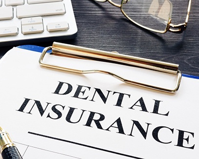 Closeup of dental insurance paperwork lying on desk