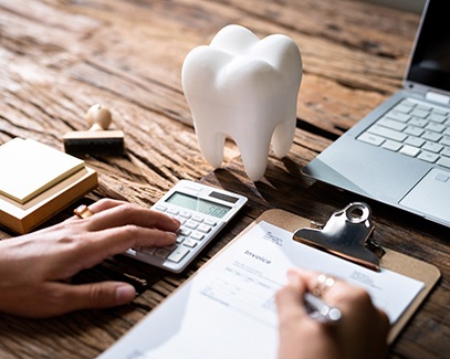 Closeup of patient calculating the cost of Invisalign in Tucson