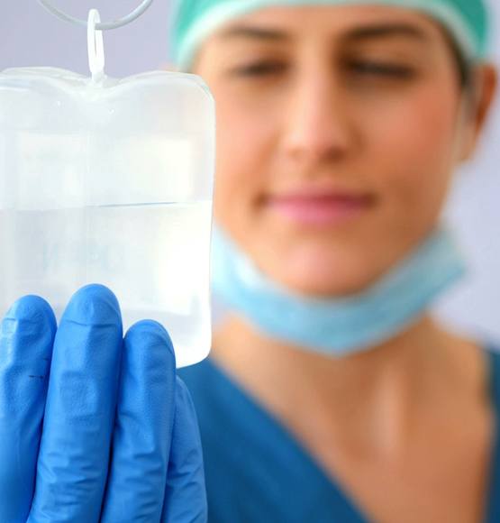 dental assistant holding IV bag 