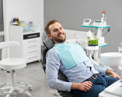 Happy patient in dental treatment chair