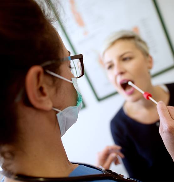 Patient undergoing saliva testing