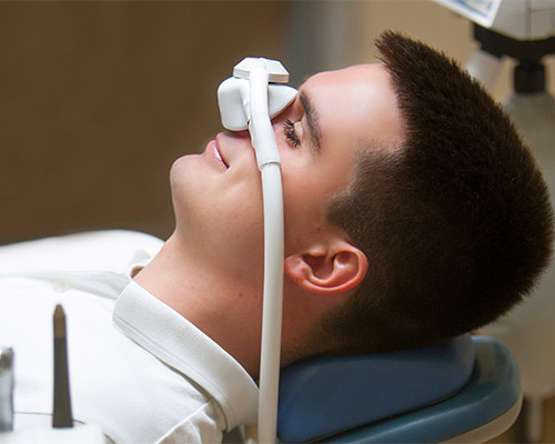 Patient with nitrous oxide dental sedation nose mask in place