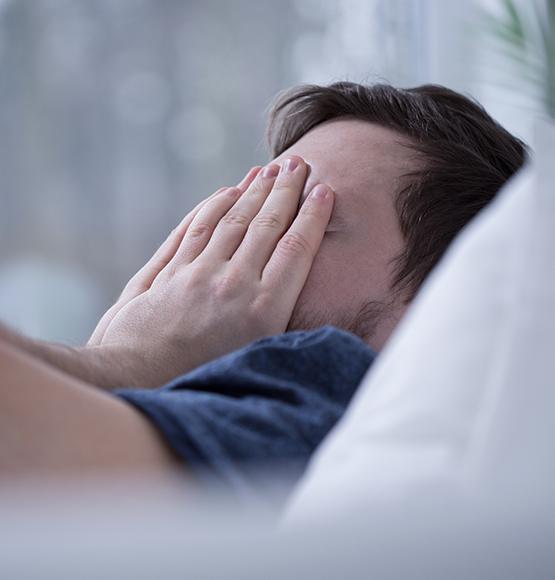 Frustrated man in need of sleep apnea therapy waking feeling tired