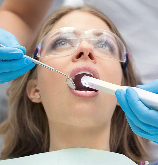 Dentist using intraoral camera to capture smile images