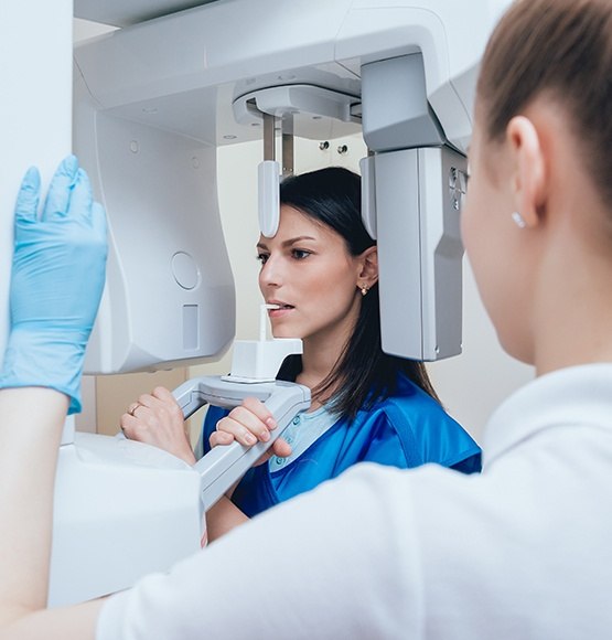 Woman receiving 3 D C T cone beam x-ray scans