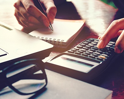 Woman calculating cost of braces in Tucson