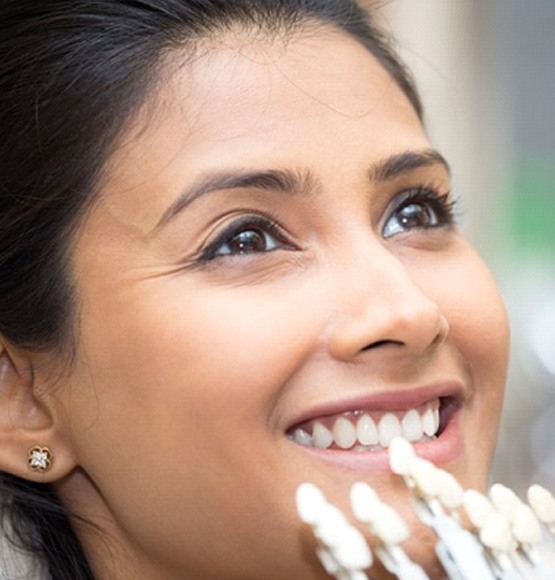 Woman smiles while getting veneers in Tucson