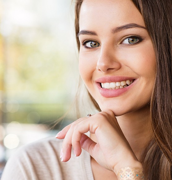 woman smiling after getting veneers in Tucson