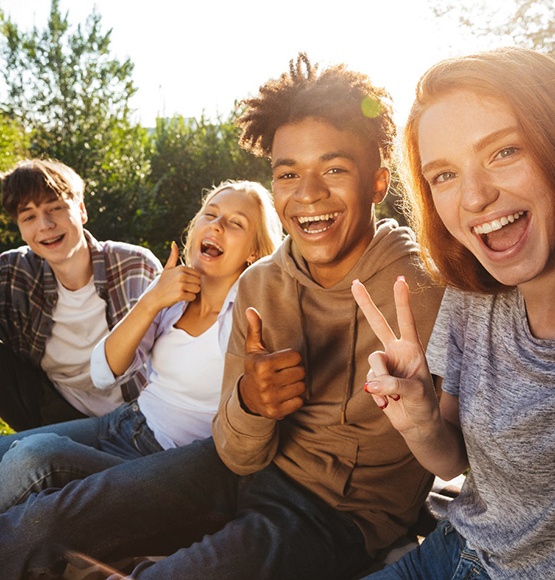 smiling teens taking a selfie together
