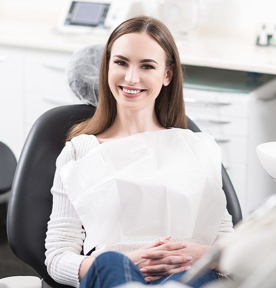 Young woman smiling after wisdom tooth extraction