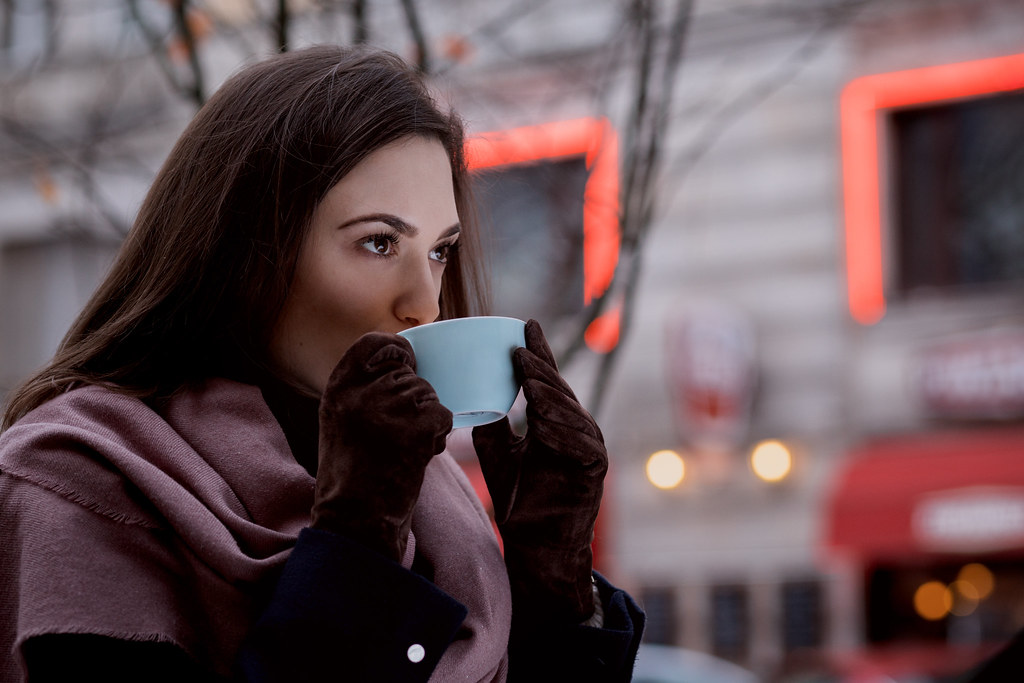 person sipping holiday drink