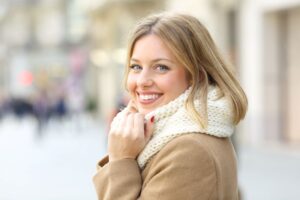 Smiling woman walking outside during cold weather